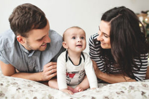 JFS Adoption - Home Studies. A young couple plays with their adopted baby.